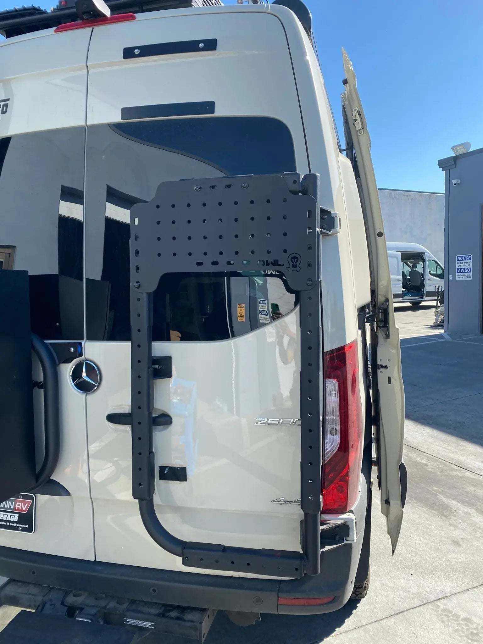 Mini Sherpa Carrier mounted on a vehicle with a rear door attachment.