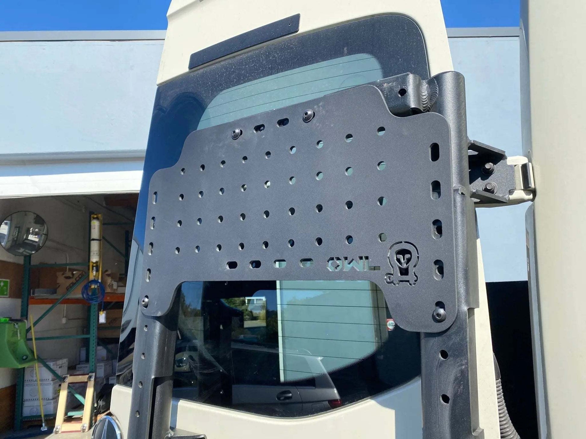 Mini Sherpa Carrier attached to a vehicle in an outdoor setting.