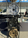Mojo Wheels for INEOS Grenadier displayed on rack at outdoor event.