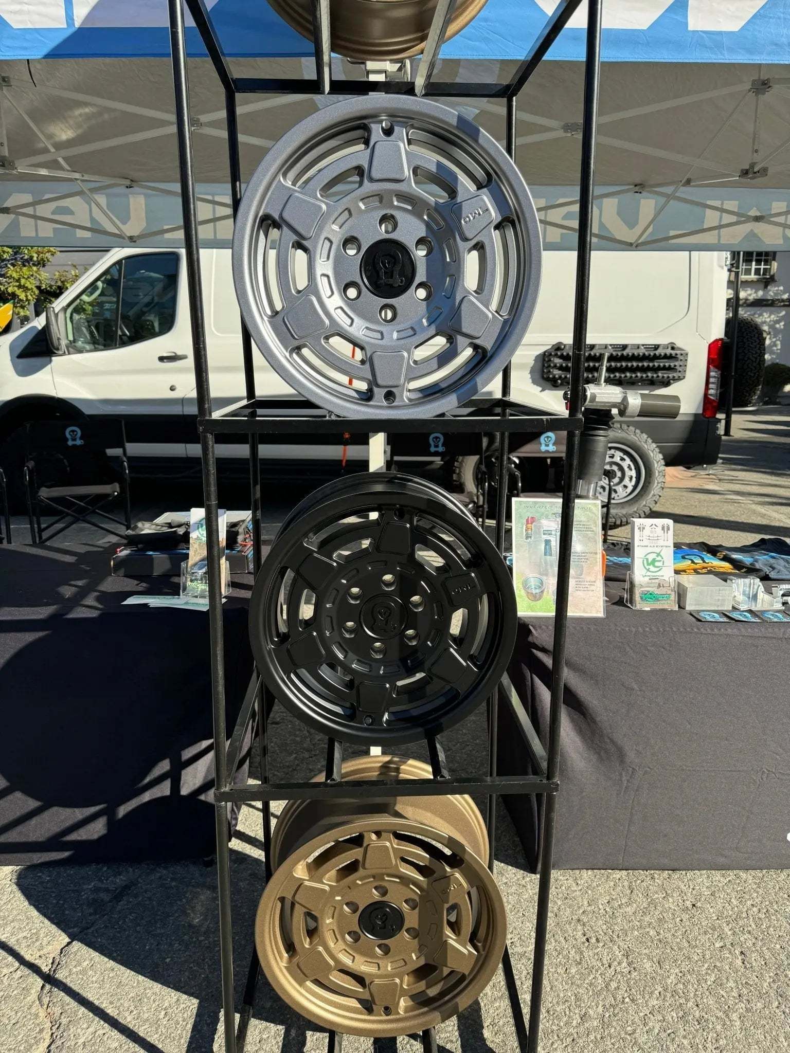 Mojo Wheels for INEOS Grenadier displayed on rack at outdoor event.