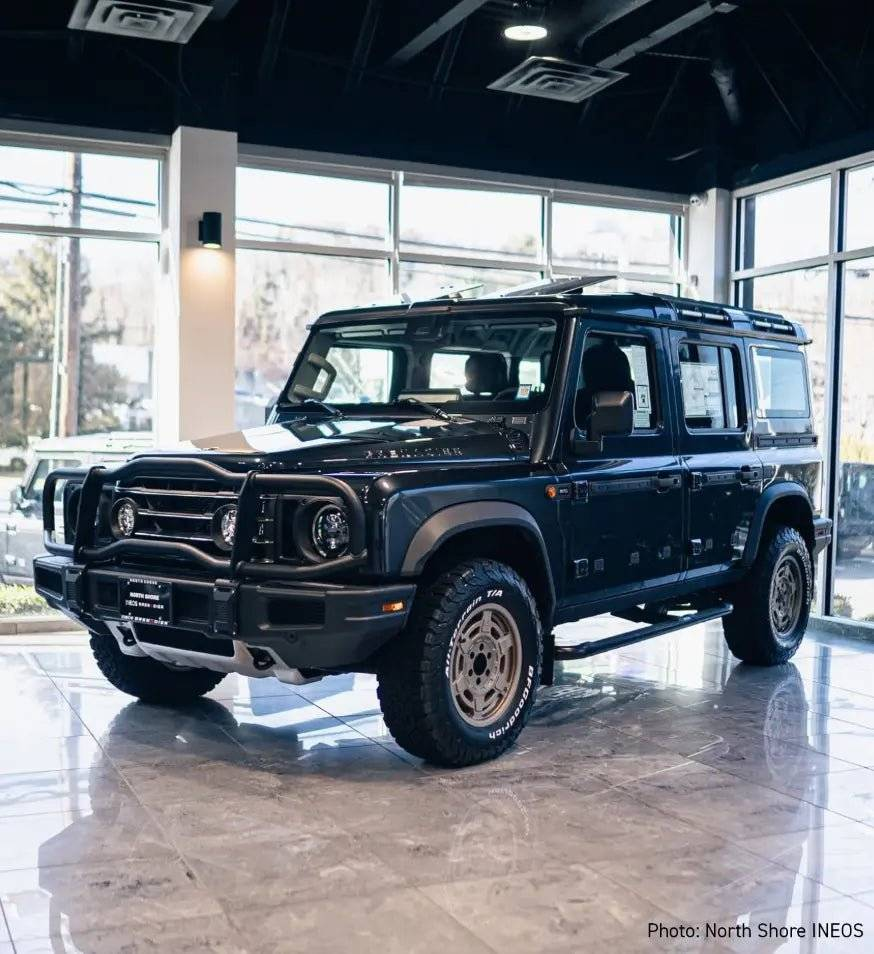 Mojo Wheels for INEOS Grenadier showcasing durability and sleek design in showroom setting.