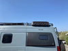Roof rack traction board mount on van for easy recovery gear access.