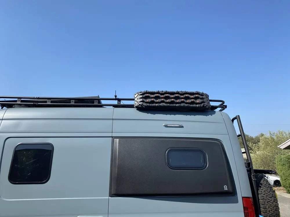 Roof rack traction board mount on van for easy recovery gear access.