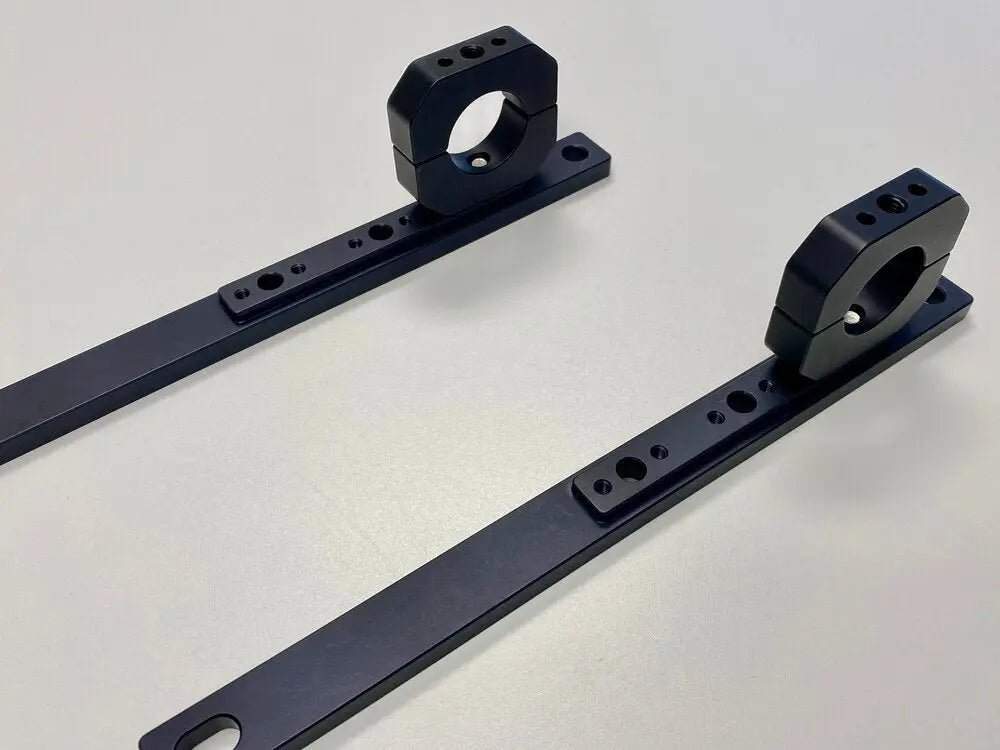 Roof rack traction board mount pair made of powder-coated aluminum for secure gear storage.