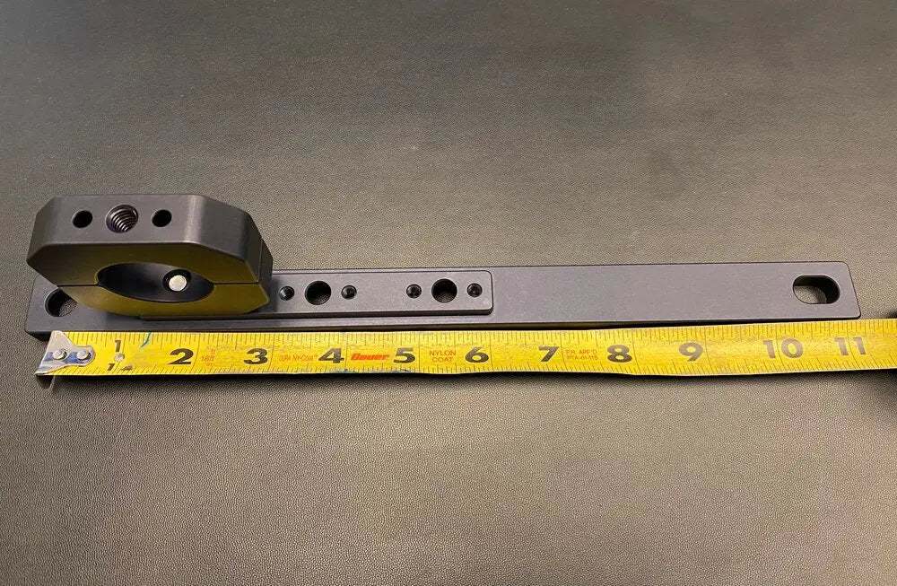 Roof rack traction board mount on measuring tape showing dimensions.