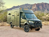 Sprinter van equipped with Talon Super Single off-road wheel set parked in desert landscape with mountains in background