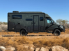 Talon Super Single wheel set-equipped Sprinter van parked in desert terrain with durable off-road design.