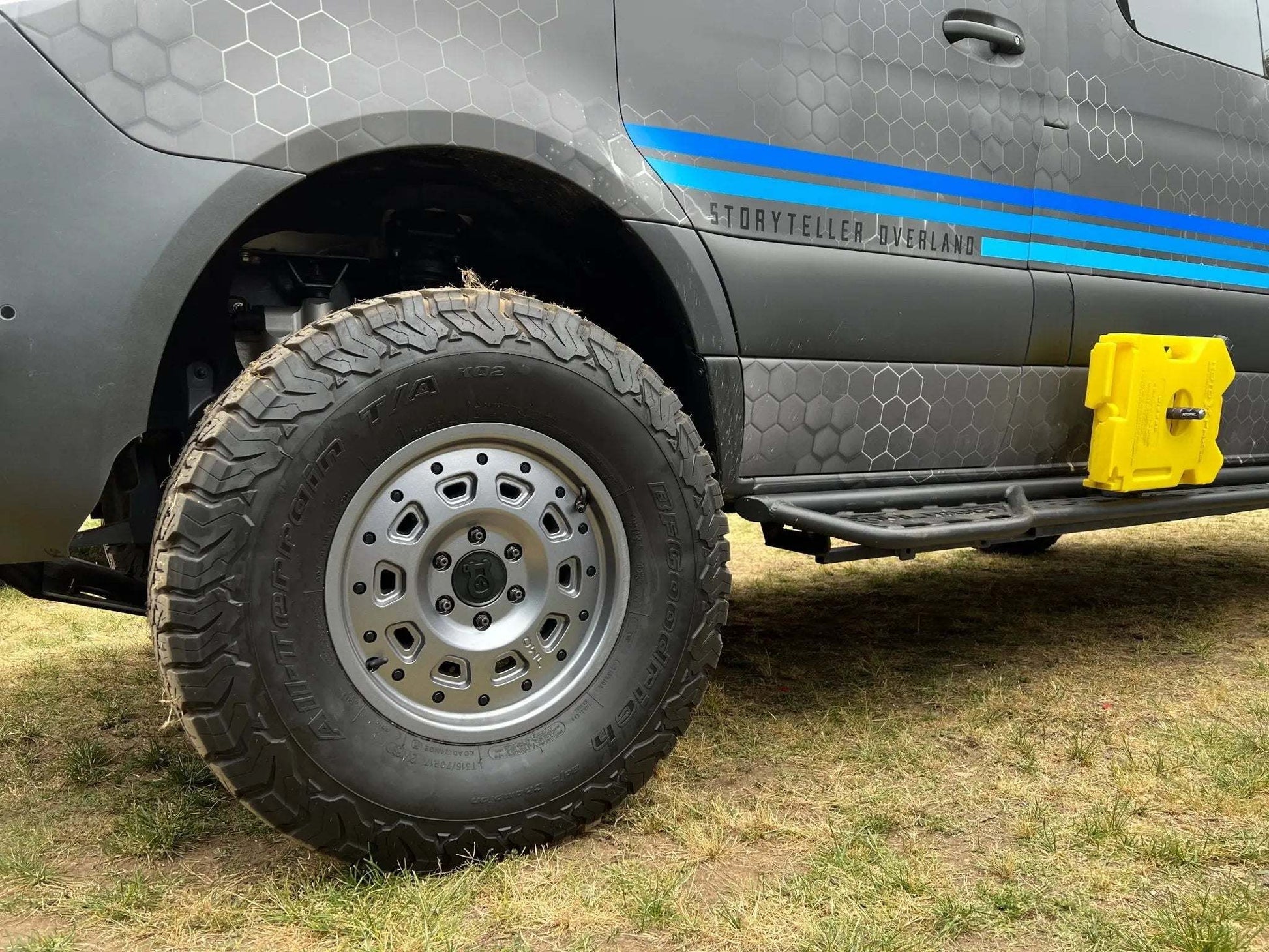 Off-road Sprinter with Super Single Spare Wheel and rugged tire on grass terrain