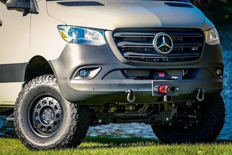 Matte black Super Single Spare Wheel on off-road Mercedes Sprinter van with aggressive tread and Owl badge