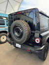 Tire relocation bracket on INEOS Grenadier for off-road utility.