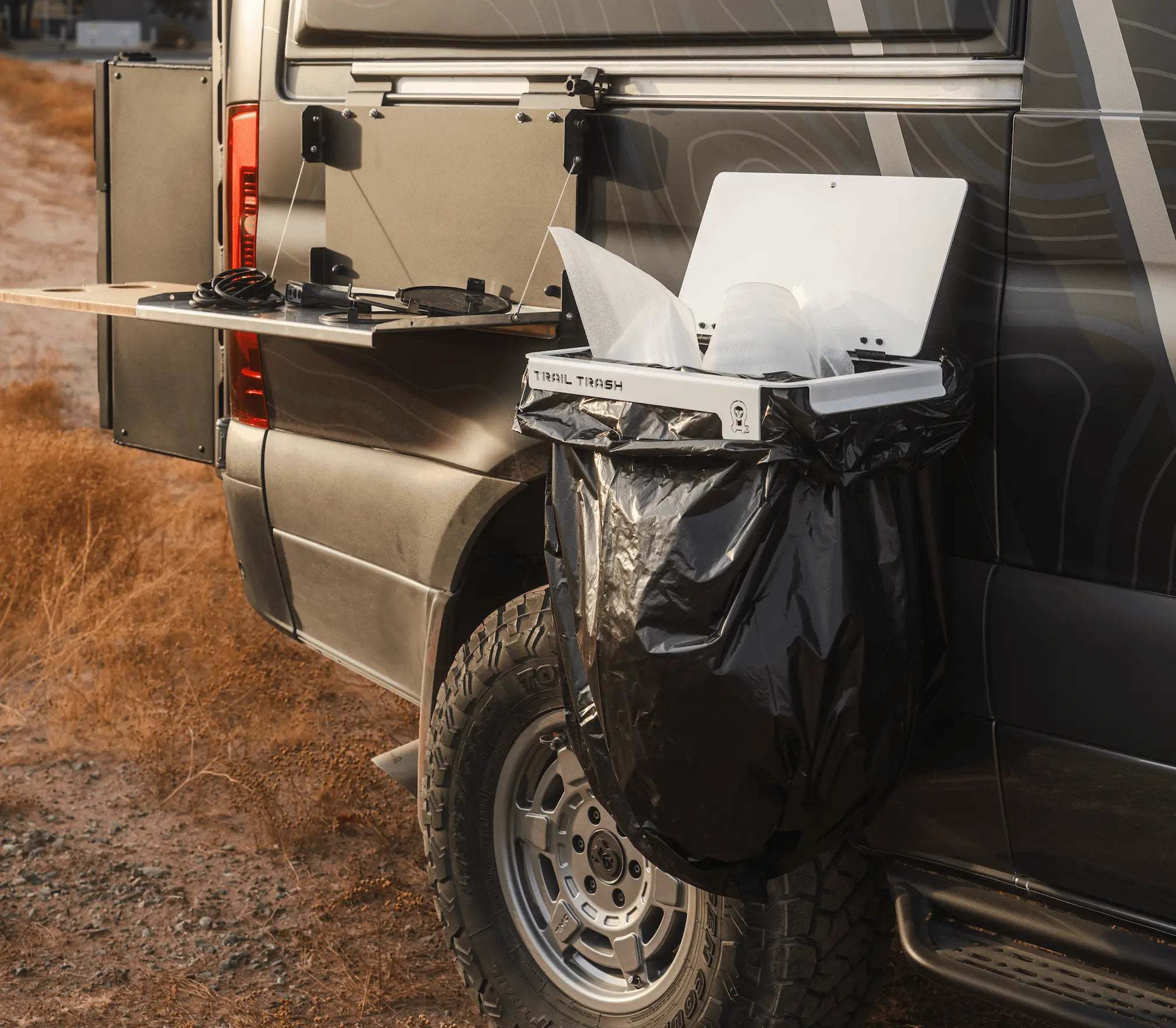 Magnetic Trail Trash holder attached to off-road vehicle with black trash bag for overlanding camping cleanup