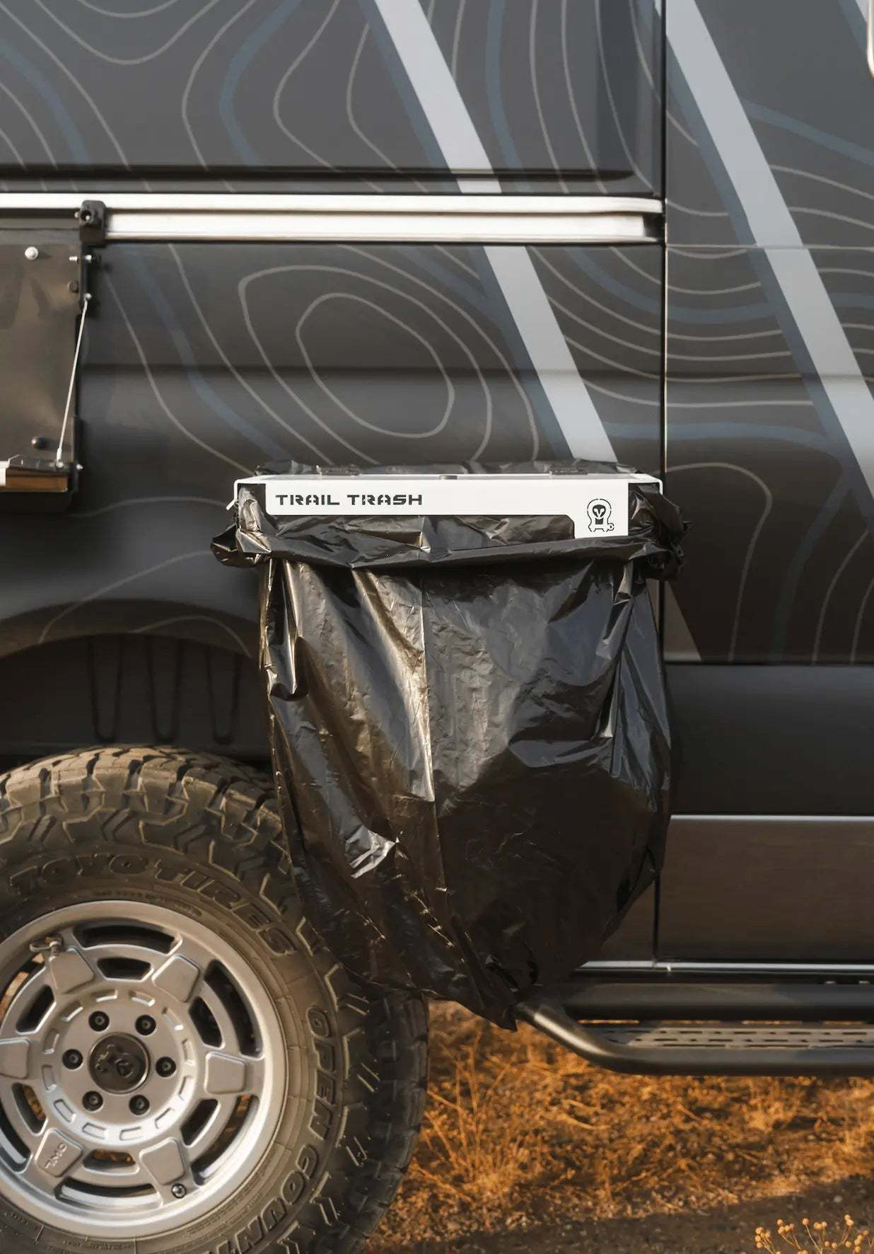 Magnetic Trail Trash holder attached to off-road vehicle for camping waste disposal