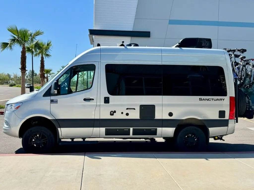 Universal Sprinter Storage Locker mounted on van, durable CNC-machined aluminum with matte black finish.