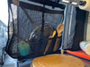 Breathable mesh camp dish drying bag hanging inside a vehicle, used for drying and storing dishes.