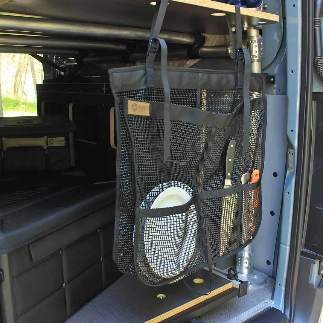 Camp Dish Drying Bag hanging in a van, used for drying and storing dishes with breathable mesh design.