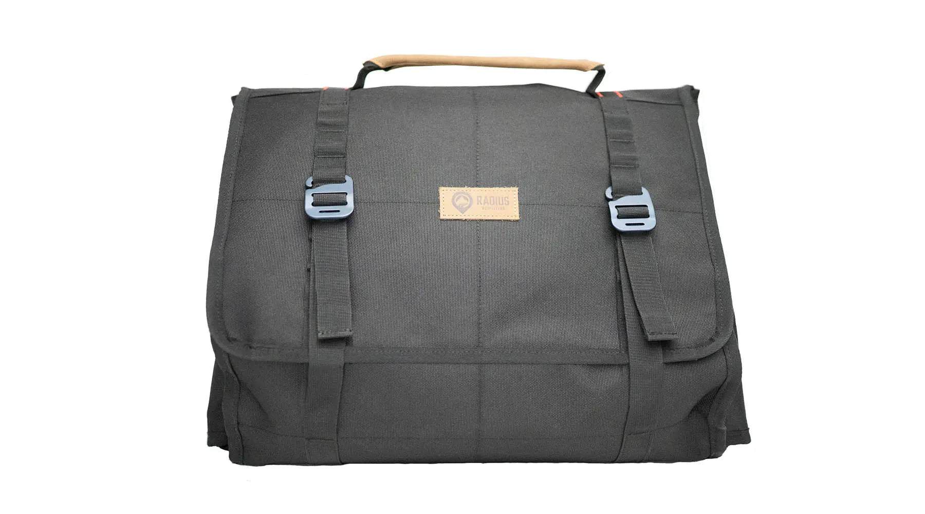 Large utility organizer with reinforced walls and MOLLE-style loops for structured storage.