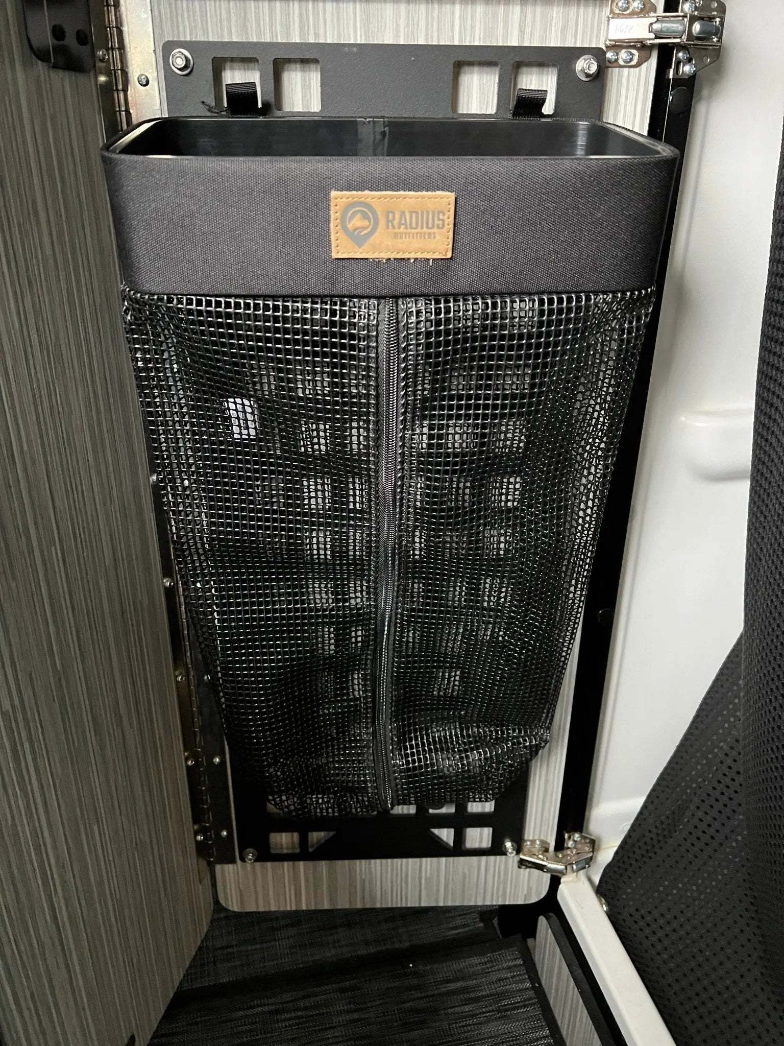 Camp Seatback Laundry Bag mounted to car seat, breathable and odor-controlling.