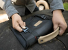 Small Utility Organizer with rugged design and compartments in use outdoors.