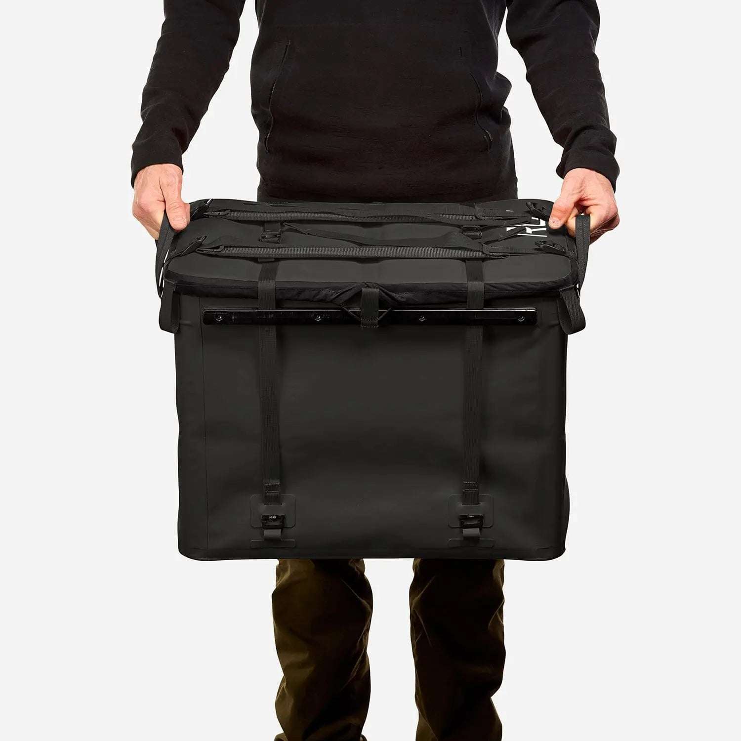 70L Storage Bag being held, showcasing durability and sleek design for adventure.