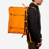 70L Storage Bag designed for durability and adventure, worn by a person.