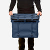 70L Storage Bag held by person, designed for durability and utility in adventure setups.