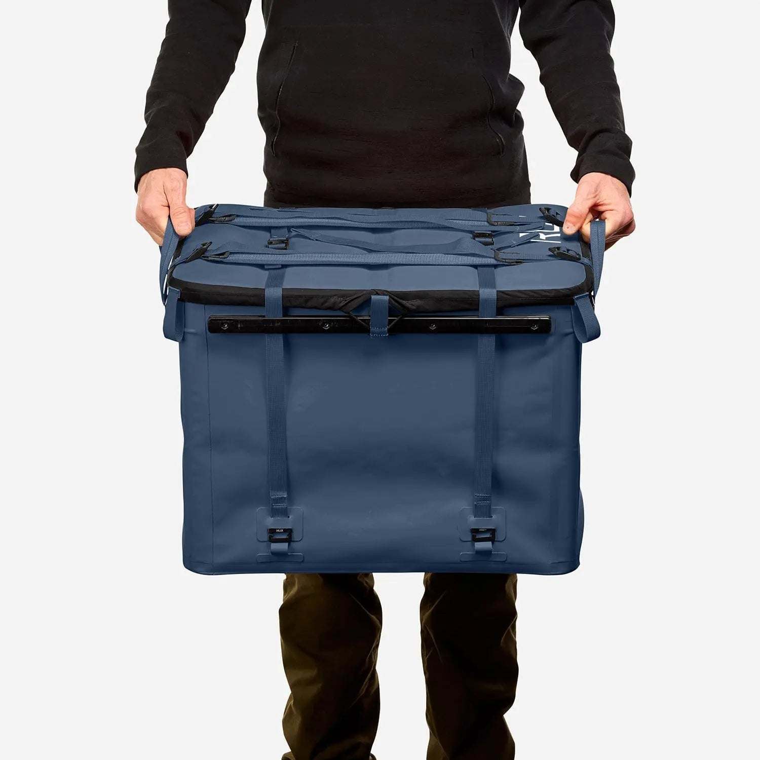 70L Storage Bag held by person, designed for durability and utility in adventure setups.