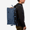 70L storage bag worn by a person, designed for durability and adventure use.