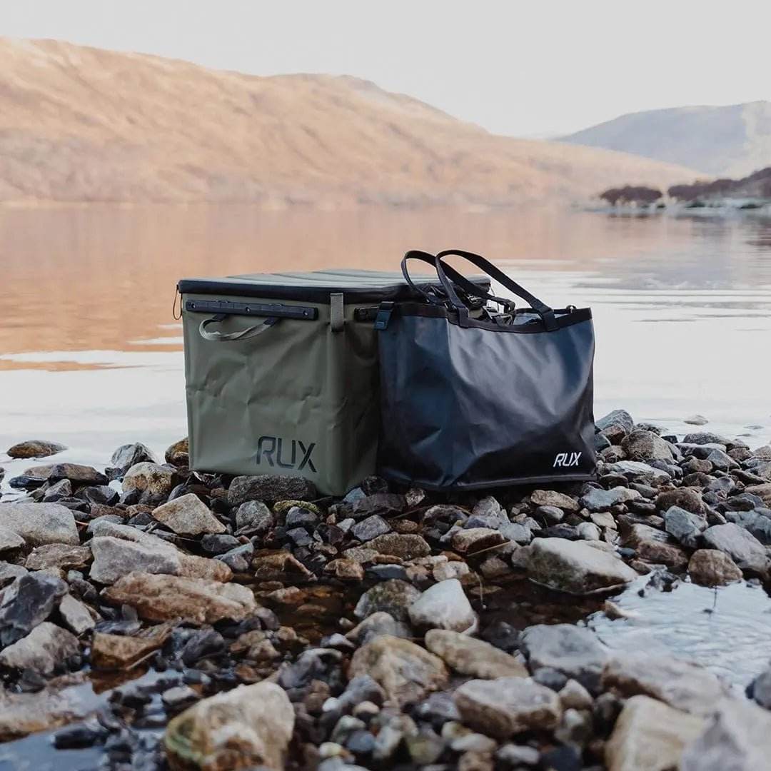 Essentials Set by RUX on rocky lakeshore, showcasing durable design for adventure and overland setups.