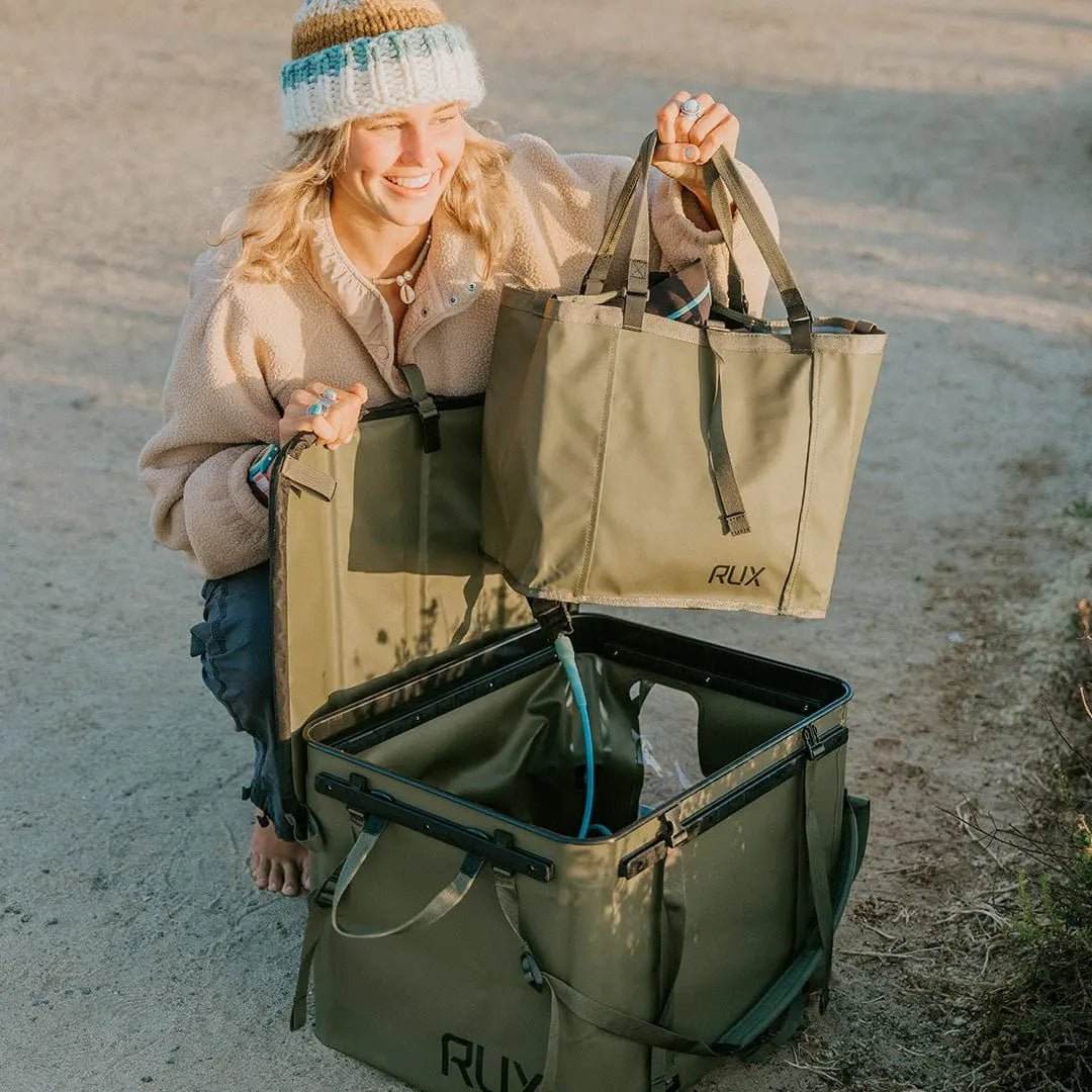 Woman with RUX Essentials Set for adventure and overland gear setup.