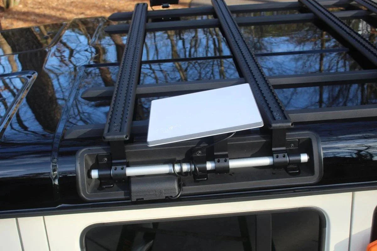 Starlink Mini Roof mount installed on INEOS Grenadier roof rails with adjustable aluminum frame and anti-theft kickstand.