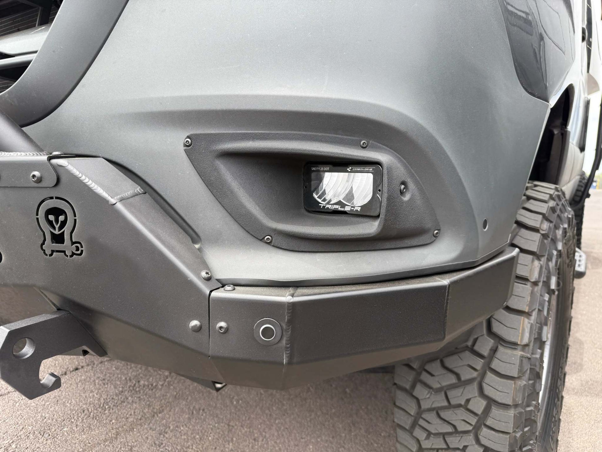 High-output Sprinter fog light upgrade installed on off-road vehicle bumper with rugged tire visible