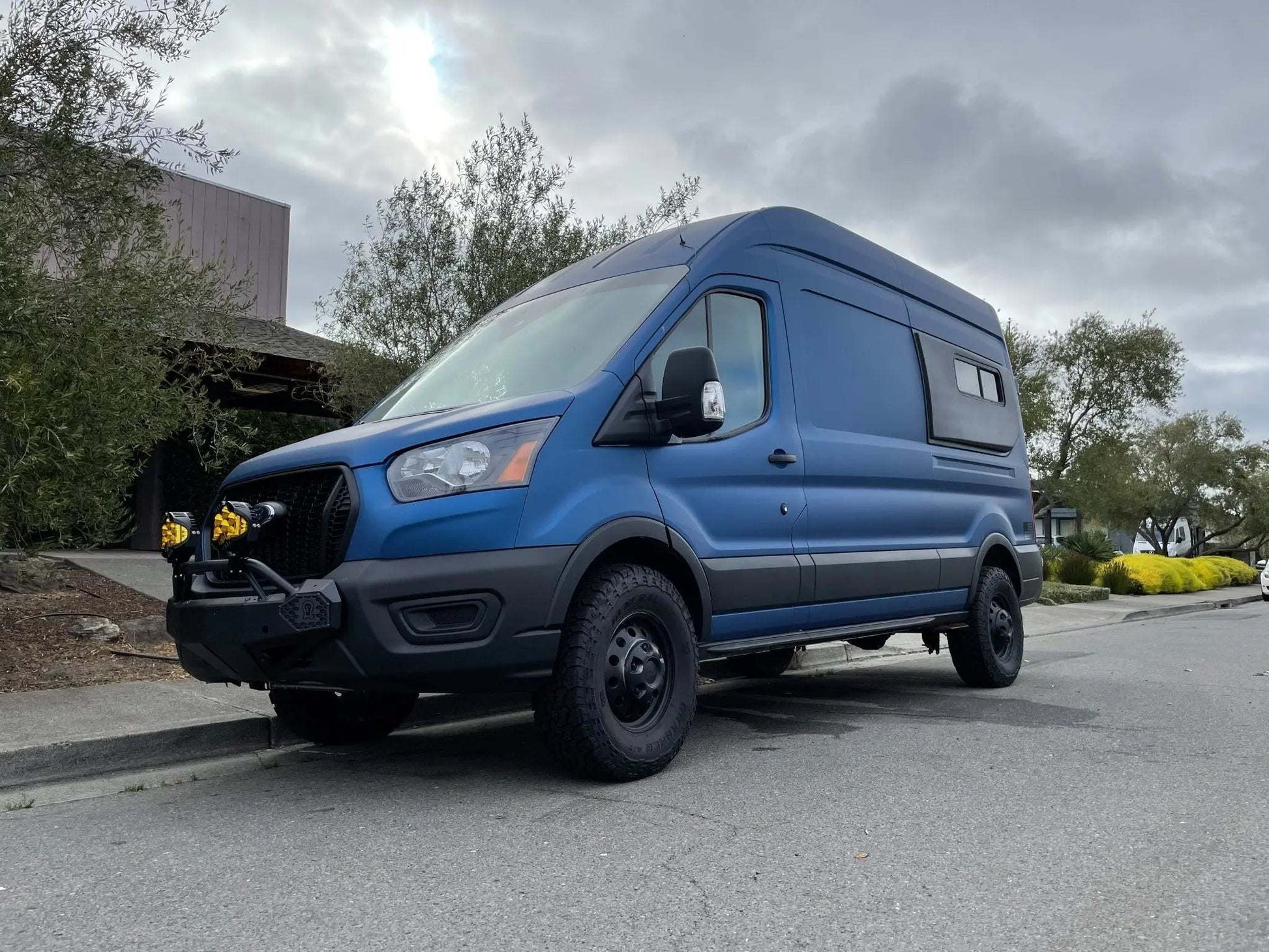 Stage 2 Topo 2.0 Suspension System on 2020+ Transit AWD van parked on road.