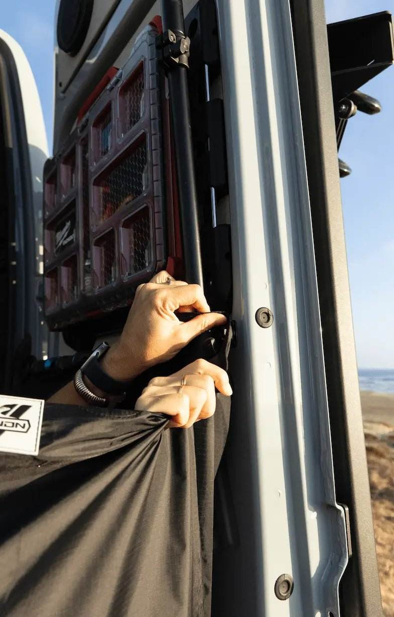 Van shower curtain being attached to rear doors for outdoor use.