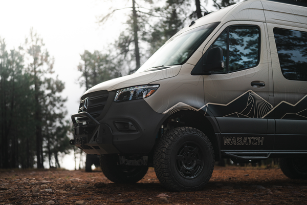 Owl x VanCraft Wasatch Halo Sprinter off-road customized adventure van in forest setting
