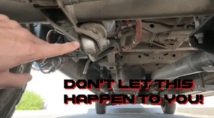 Hand pointing at bent bottom shock bracket under a Sprinter van with warning text to prevent bottom shock bracket failure