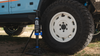 Grenadier SUV truck jack lifting offroad vehicle tire with high performance bottle jack outdoors