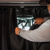 Black insulated Sprinter curtain with magnetic tabs for cab and living space separation in a van