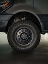 Matte black Talon Sprinter Wheel with multi-spoke design and off-road tire on van