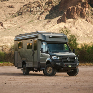OTX Tiffin adventure van parked in desert landscape with mountainous background