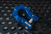 Blue aluminum D-shackle set on textured black surface for off-road recovery.