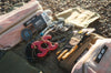 Overland INEOS SUV recovery kit with kinetic rope, gloves, modular MOLLE bag, and hitch receiver on gravel background