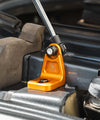Close-up of orange anodized billet aluminum mount of Sprinter Hood Strut Kit installed on vehicle hood.