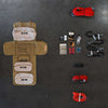 Overland INEOS SUV recovery kit with modular rollup bag, kinetic rope, tree saver, HMPE bridle, soft shackle, gloves, hitch recovery point, and barrel head hitch pin on dark surface