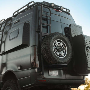 Sprinter tire carrier and ladder mounted on black 2019+ Sprinter rear door with roof rack and gear storage