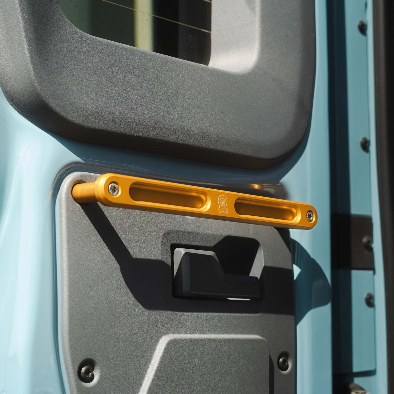 Grenadier Rear Grab Handle in gold mounted on vehicle rear door for off-road utility and durability