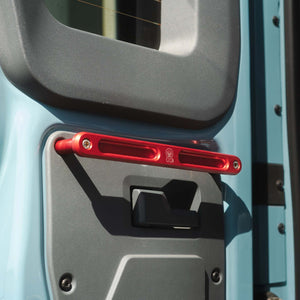 Red Grenadier Rear Grab Handle mounted on vehicle rear door designed for durability and utility