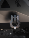 9-ton black aluminum D-shackle with Owl logo attached to vehicle bumper for off-road recovery.