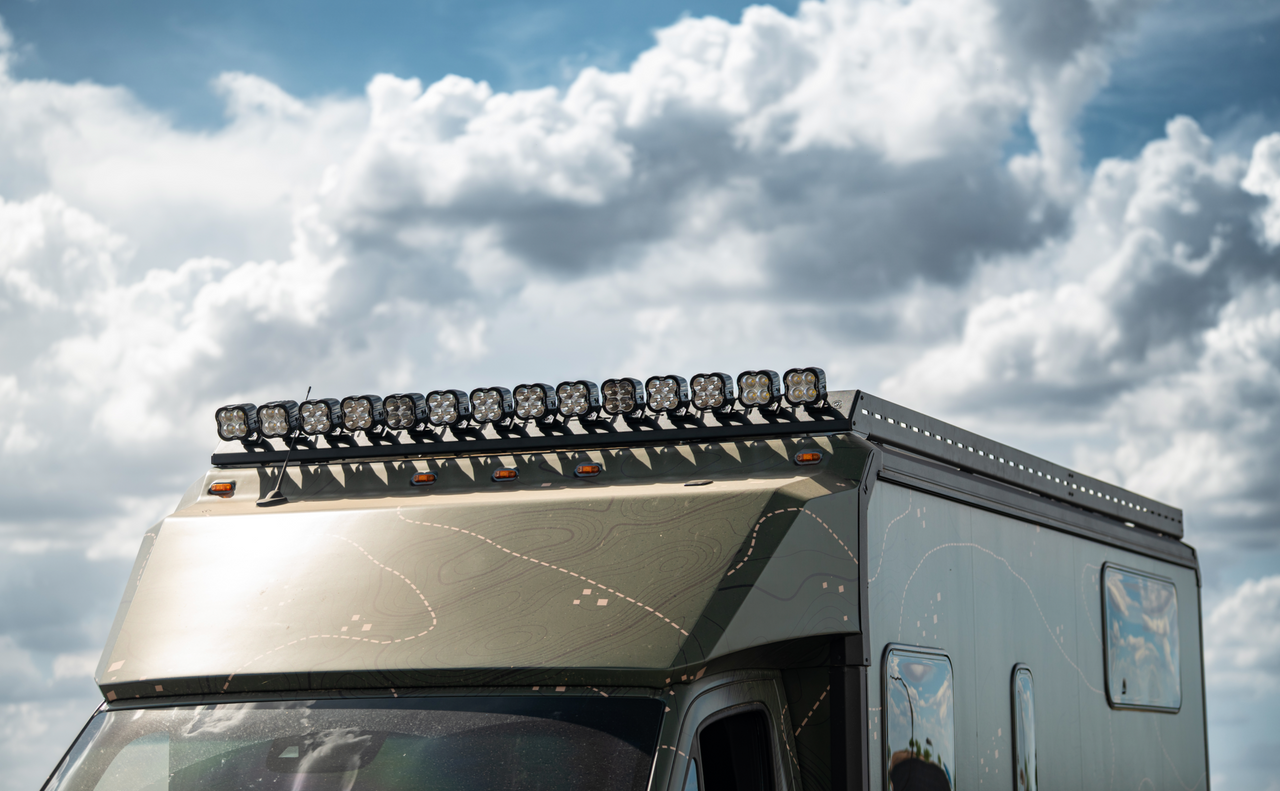 Winnebago Ekko with Ekko Roof Rack Teton Edition and multiple off-road lights mounted on top under cloudy sky