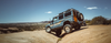 Off-road INEOS Grenadier vehicle equipped with Trail-Flo 2"-4" lift Grenadier Suspension on rocky terrain