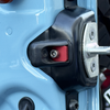 Close-up of rear door washer and rubber bumper mounted on light blue INEOS Grenadier door frame
